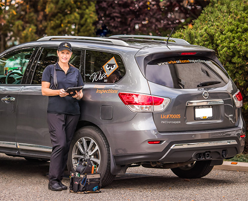 Trish Wise standing in front of company car